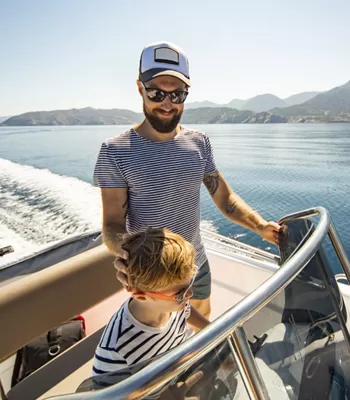father and son driving boat