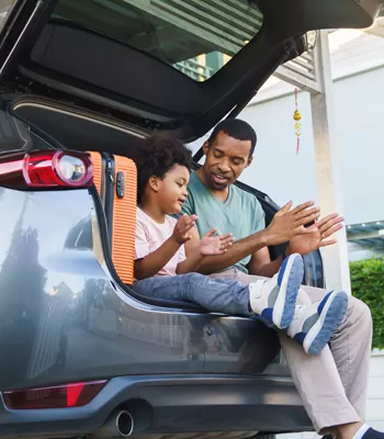 family in car ready for road trip