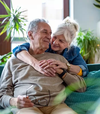 older couple sitting on couch enjoying each others company