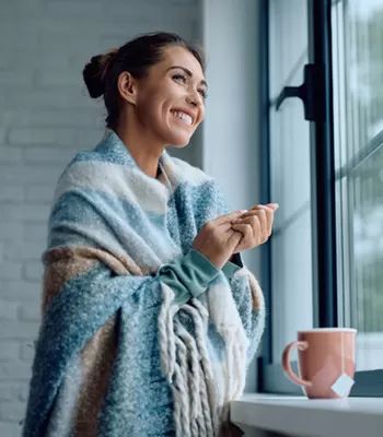 woman looking out window in winter season