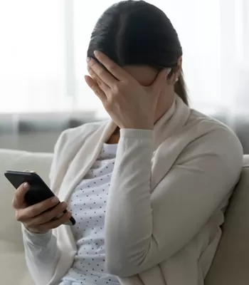 happy woman using iPad on couch
