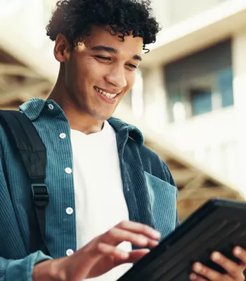 young man attending college using tablet