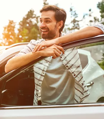 man with car standing in field