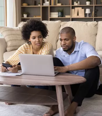 couple review finances on computer