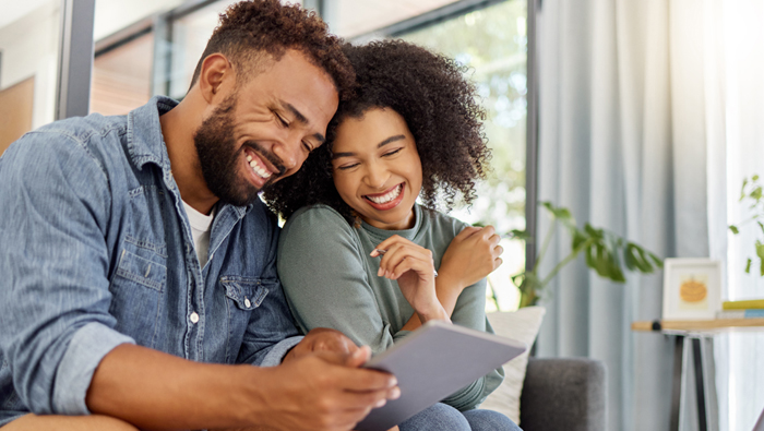 couple smiling at a financial statement