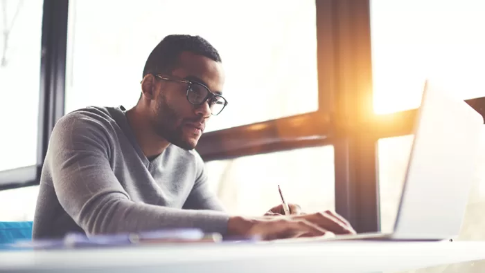 man using computer to review finances