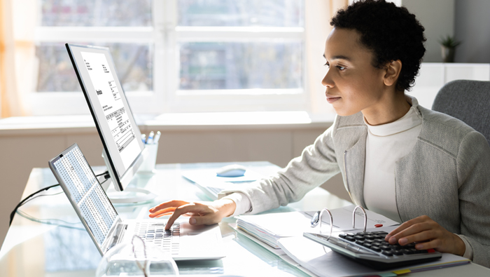 young person review financials on laptop