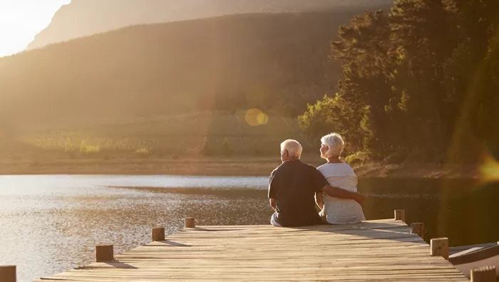 happy couple sitting on dock