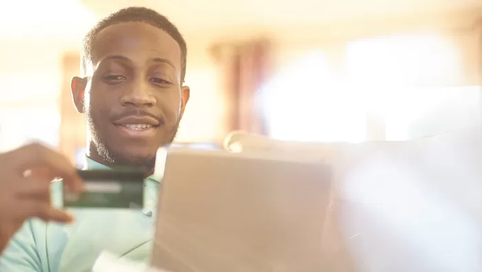 man with card using computer