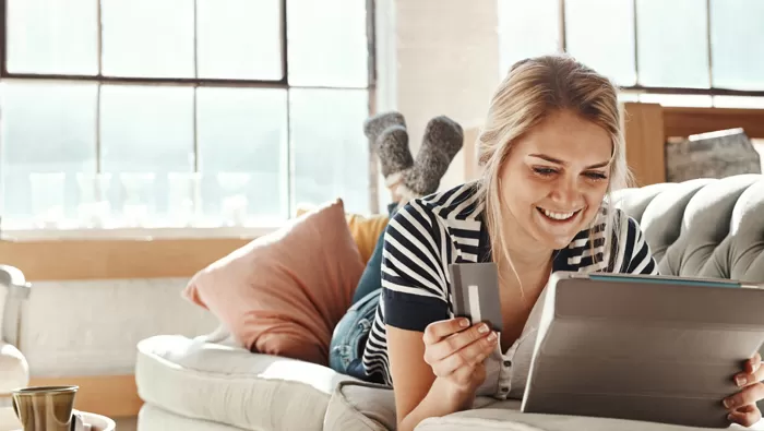 woman with card using computer