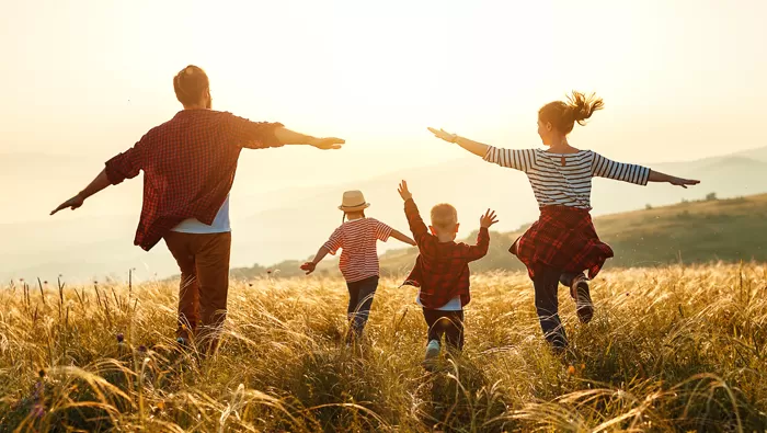 family in field sunshine