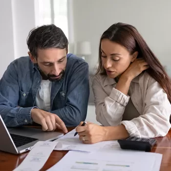 couple reviewing finances working towards debt consolidation plan