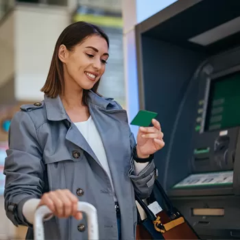 young woman using ATM