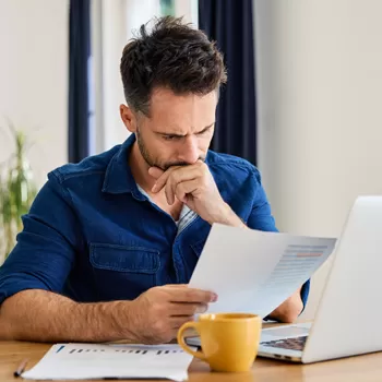 stressed man reviewing financial statements