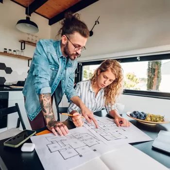 couple reviewing remodeling plans in kitchen
