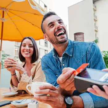 couple out to eat using credit card to pay