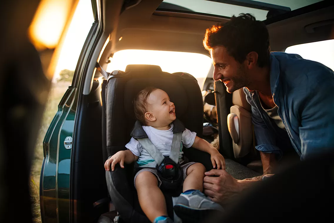 father and son in car with sunsetting