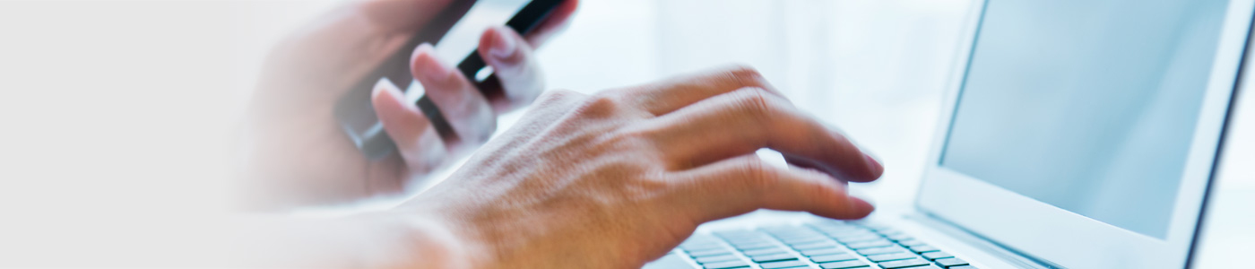Hand typing on laptop